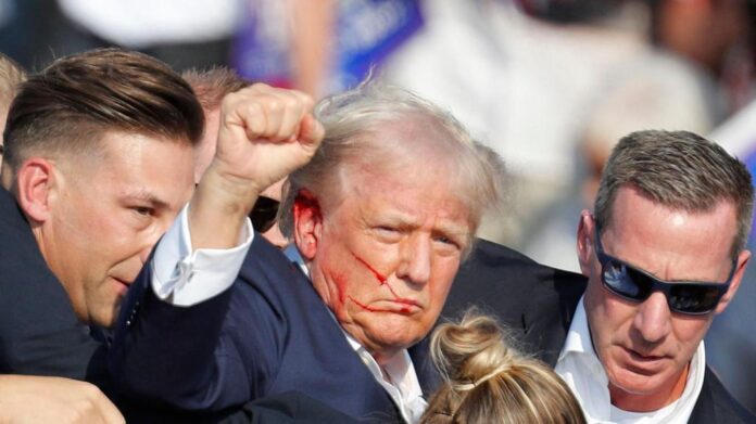 Former President Donald Trump escorted off stage by Secret Service during a rally in Butler, Pennsylvania, after gunshots were heard in the crowd.