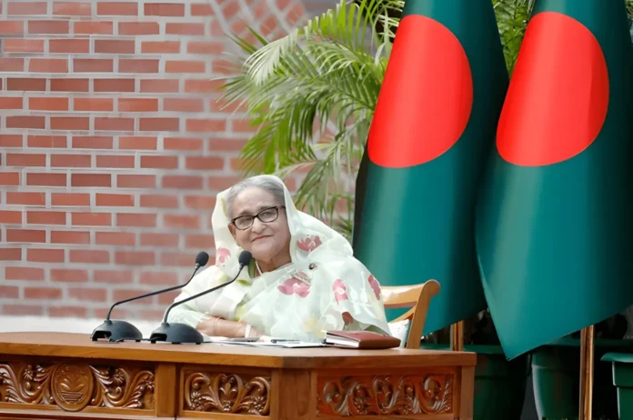 Sheikh Hasina, Prime Minister of Bangladesh, speaking at a public event, showcasing her leadership and influence on the nation’s progress